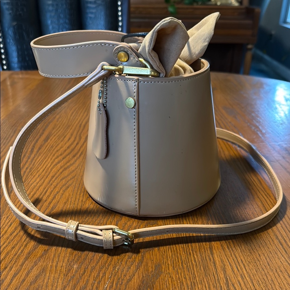 Tan Crossbody Bag with Adjustable Strap and Metallic Hardware